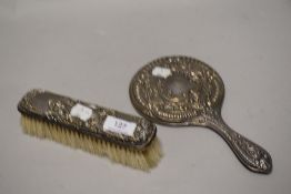 A Hm silver dress brush with a repousse design