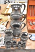 An Aquinas Locke pewter set of graduated measuring tankards nine in total