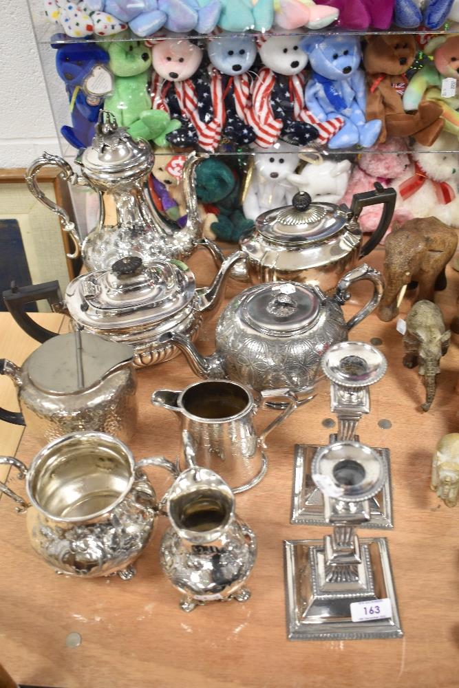 A selection of silver plated table wares including a tea set, three tea pots and a pair of