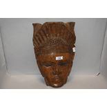 A wooden South American hand carved native wooden mask