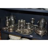 A selection of silver plated serving wares including muffin dish, serving tray, goblets and a pair