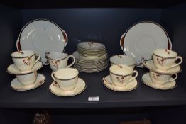 An early 20th century Art Deco design Royal Doulton part tea service in a red black and cream