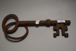 A very large over sized cast iron door key 30cm long