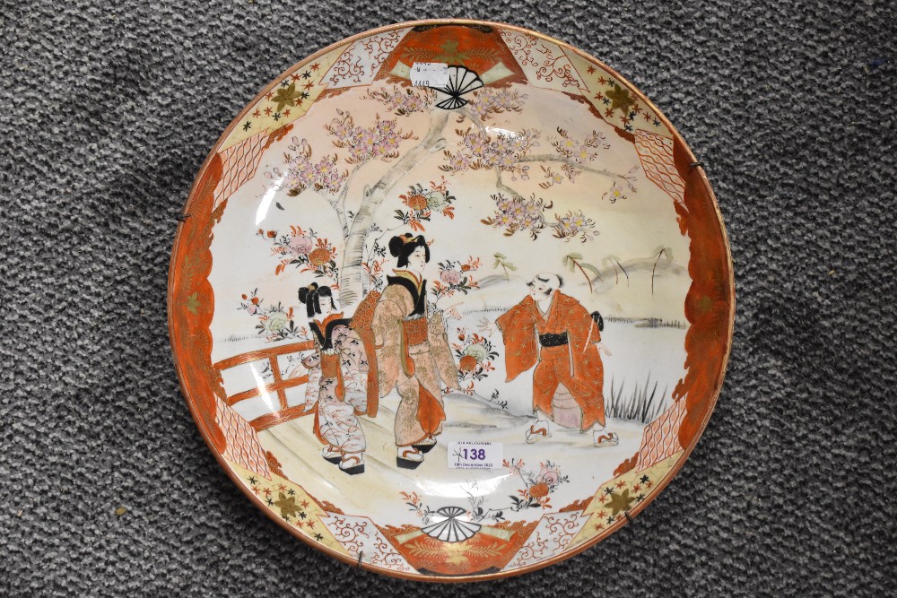 A Meiji Kutani ware pattern charger depicting mother and daughter in discussion with villager