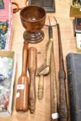 A selection of treen wood items including a knitting stick, distaff, clubs and a toasting fork