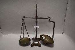 A set of Victorian apothecary or similar balance scales, cast iron frame with brass pans