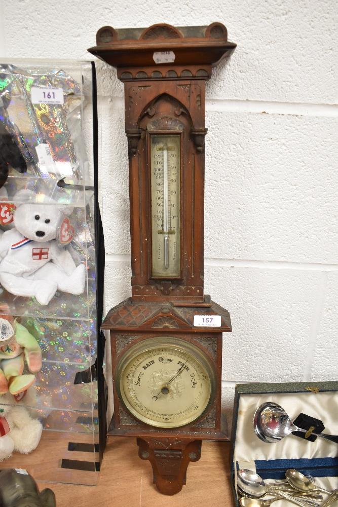 A Victorian Gothic design barometer with carved mahogany case