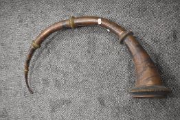 An antique Nepalese Ransingha horn or trumpet having copper body and brass rings
