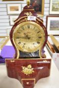 A modern Eluxa bracket eight day clock in a boulle style design and accompanying bracket also