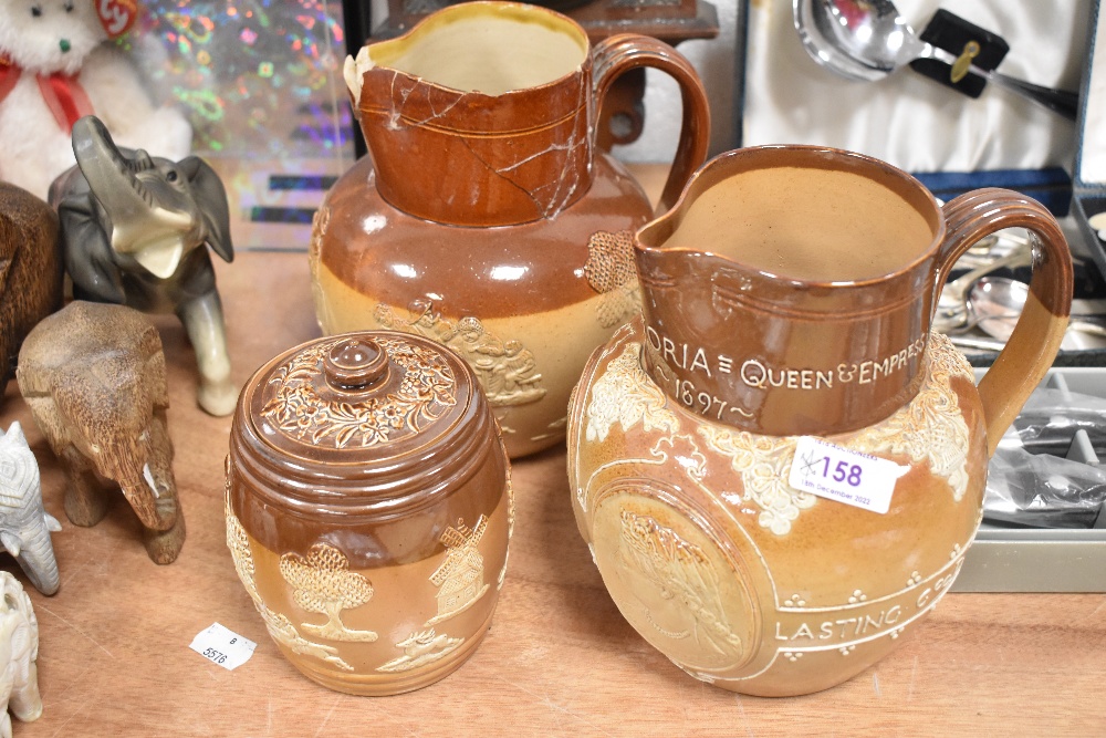 Three pieces of Doulton Lambeth including Queen Victoria 1837 - 1897 jug, tobacco jar and similar