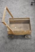 A vintage hand made child trolley