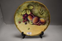 A modern Royal Worcester cabinet display plate having hand decorated panel of a fruit study by S.