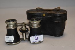 A vintage pair of small sized binoculars no makers name found and having fitted case