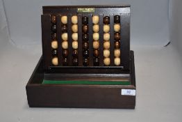 A modern Remy Martin Cognac games counter case with turned wooden balls