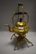 A late Victorian spirit burner kettle with stand having brass case with embossed design and twist