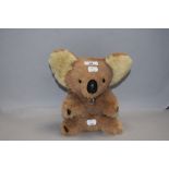 A modern plush cuddly toy Koala bear having musical mechanism for Waltzing Matilda 24cm tall