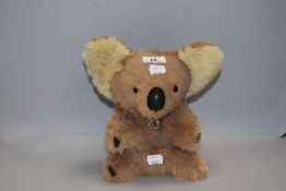 A modern plush cuddly toy Koala bear having musical mechanism for Waltzing Matilda 24cm tall