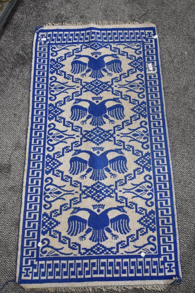 A blue and grey Turkish style flat weave prayer rug.