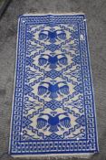 A blue and grey Turkish style flat weave prayer rug.