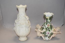 A late Victorian Sitzendorf porcelain vase decorated with two cherubs and rose bush, One cherub