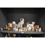 A large collection of ceramic cat and dog figure studies including half a bookend, pipe holder and