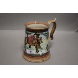 A large ceramic tankard hand decorated with a fox hunting scene