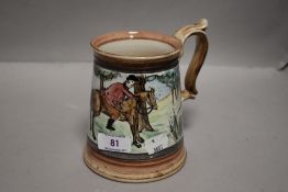 A large ceramic tankard hand decorated with a fox hunting scene