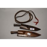 Two early 20th century small sized Kukri knives in wooden sheaths with a small whip