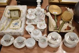 A selection of dressing table brushes and mirrors with a dolls house tea service