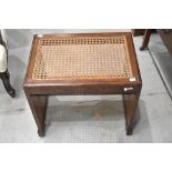 An Art Deco oak stool having canework seat