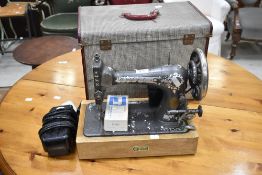 A vintage Universal sewing machine and accesories