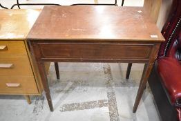 An Edwardian mahogany side table having drawer to end, line inlay decoration and square tapered