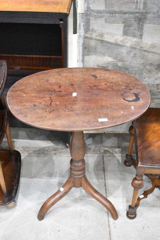 A 19th Century pedestal table having oval mahogany top and oak column with triple splay legs