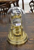 A brass anniversary clock#, signed Gustav Becker having glass dome top