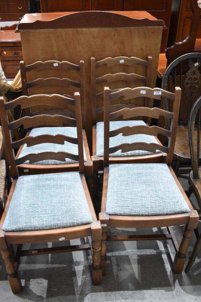 A set of four Priory style shaped ladder back dining chairs