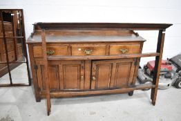 A period oak dresser having open delft rack over drawer and cupboard base, width approx. 137cm