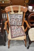 A traditional stained frame Windsor style spindle back carver chair having turned frame and H