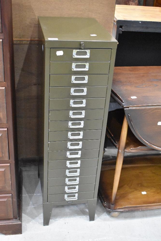 A set of metal filing drawers, in khaki green