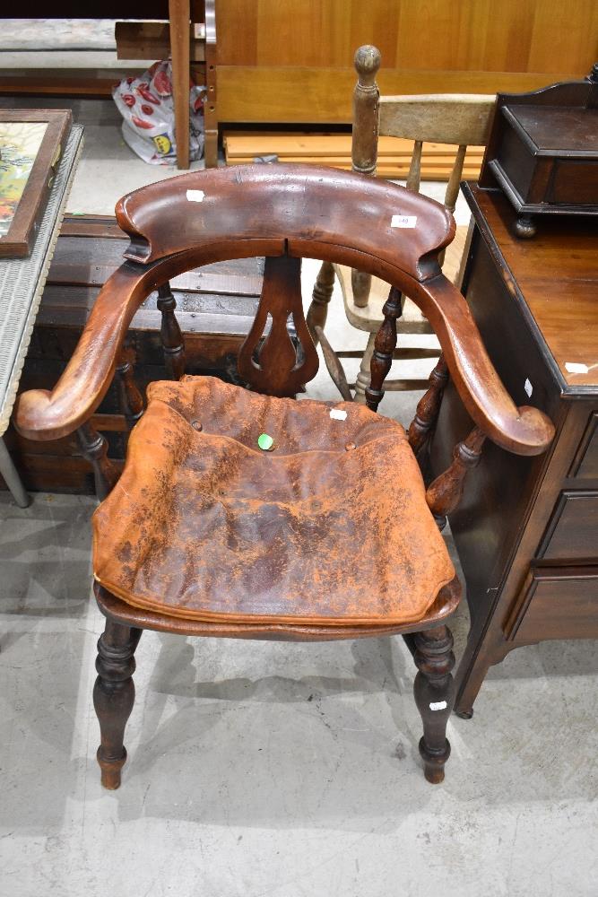 A late 19th or early 20th Century stained frame office arm chair