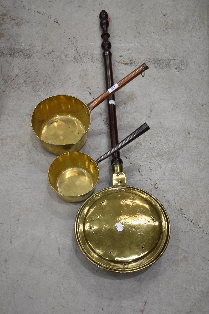 Two antique brass pans and warming pan