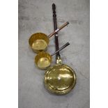 Two antique brass pans and warming pan