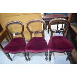 Three Victorian balloon back dining chairs with carved details and turned legs