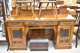 A Victorian Aesthetic sideboard having brass handles, carved detailing and shaped ledge back,