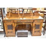 A Victorian Aesthetic sideboard having brass handles, carved detailing and shaped ledge back,