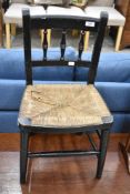 A 19th Century childs spindle back chair having rush seat