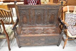 A period oak settle of nice proportions having carved detailing with monogram and date (SM 1708),