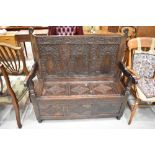 A period oak settle of nice proportions having carved detailing with monogram and date (SM 1708),