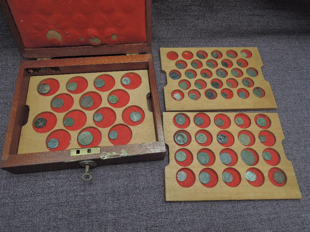 A wooden lockable case containing three trays of Roman Coins and one Hammered Coin, 60 in total