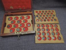 A wooden lockable case containing three trays of Roman Coins and one Hammered Coin, 60 in total