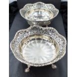A pair of silver bon bon dishes of circular form having moulded and pierced decoration and hoof